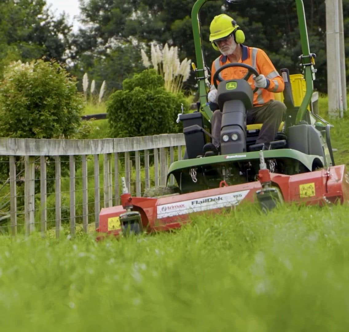 Team member mowing grass